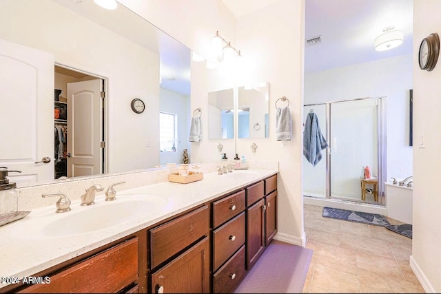 bathroom featuring tile patterned floors, vanity, and walk in shower