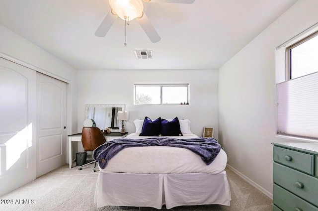 carpeted bedroom with ceiling fan and a closet