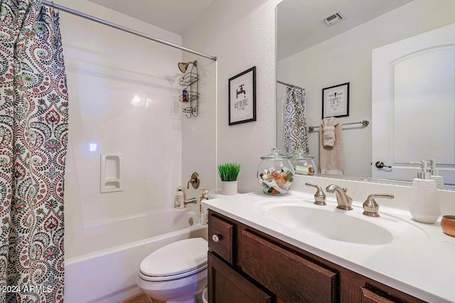 full bathroom with vanity, shower / bath combo, and toilet