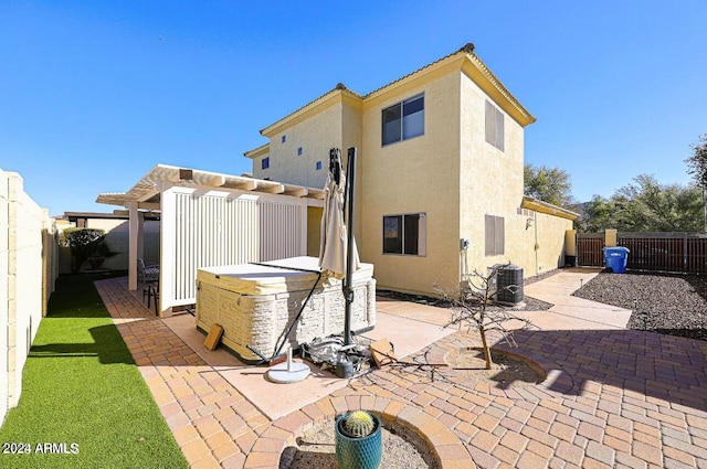 rear view of property with a pergola, central AC, and a patio area