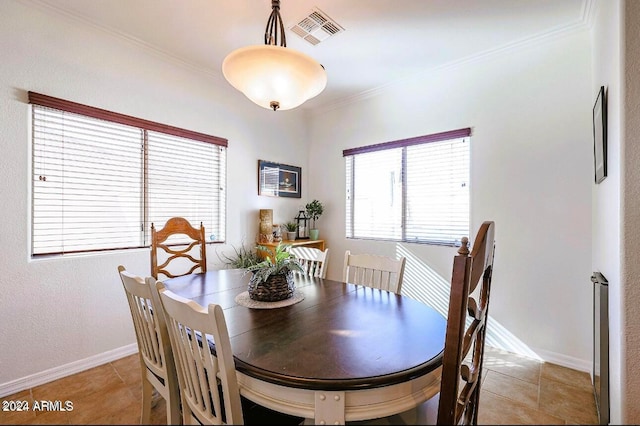 tiled dining space with crown molding