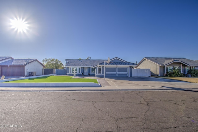 single story home featuring a front lawn and a garage