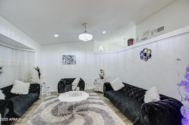 living room featuring hardwood / wood-style flooring and a textured ceiling