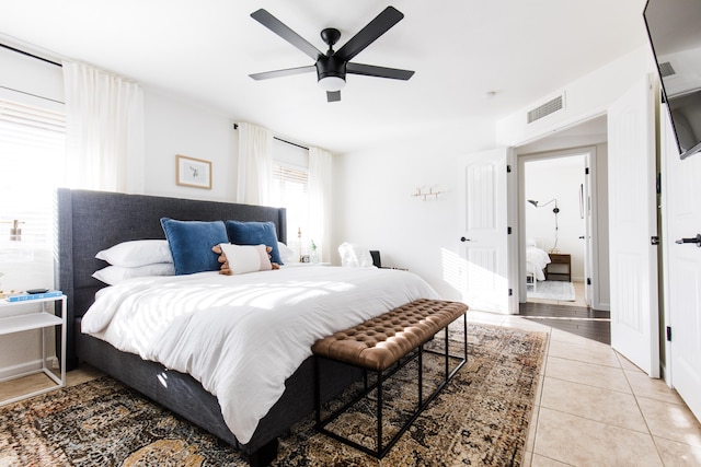 bedroom with light tile patterned floors, visible vents, and ceiling fan