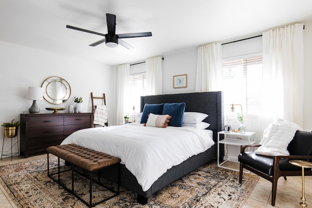 bedroom featuring light tile patterned flooring and ceiling fan