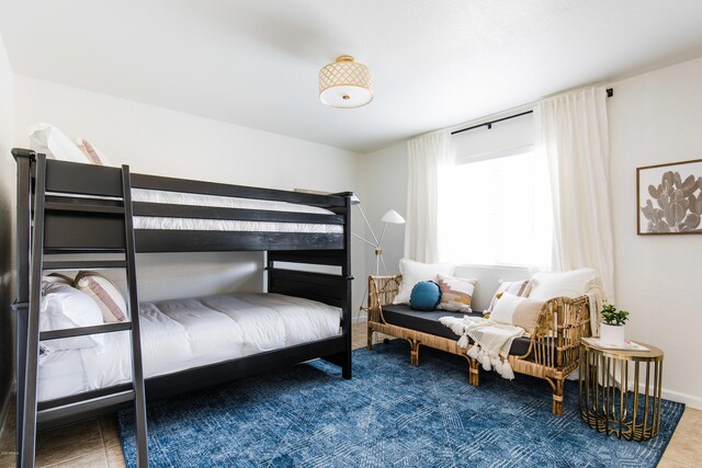 bedroom with tile patterned floors and baseboards