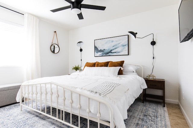 bedroom with a ceiling fan and baseboards