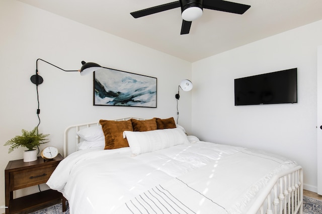 bedroom featuring a ceiling fan and baseboards