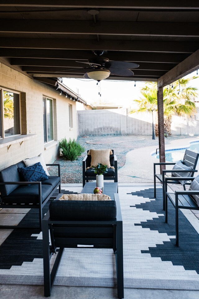 view of patio featuring a fenced in pool, outdoor lounge area, ceiling fan, and fence