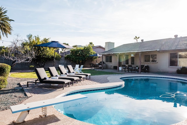 view of swimming pool with a fenced in pool, grilling area, a fenced backyard, and a patio area