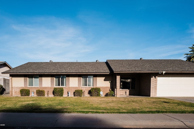 single story home with driveway, roof with shingles, a front lawn, a garage, and brick siding