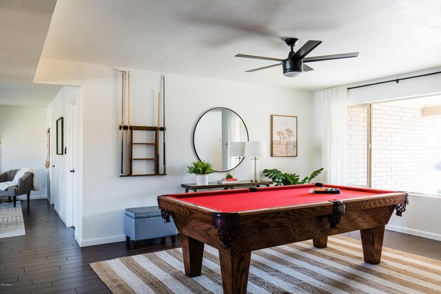 game room featuring dark wood-type flooring, a ceiling fan, and a wealth of natural light