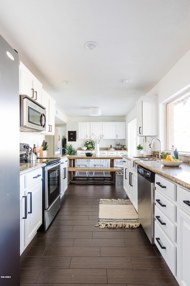 kitchen featuring white cabinets, dark wood-style floors, and appliances with stainless steel finishes