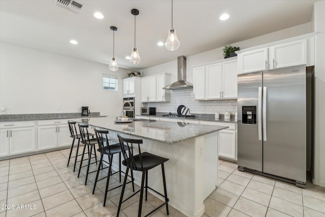 732 W Flintlock Way, Chandler, AZ 85286 - kitchen featuring stainless steel appliances, wall chimney range hood, white cabinets, and recessed lighting