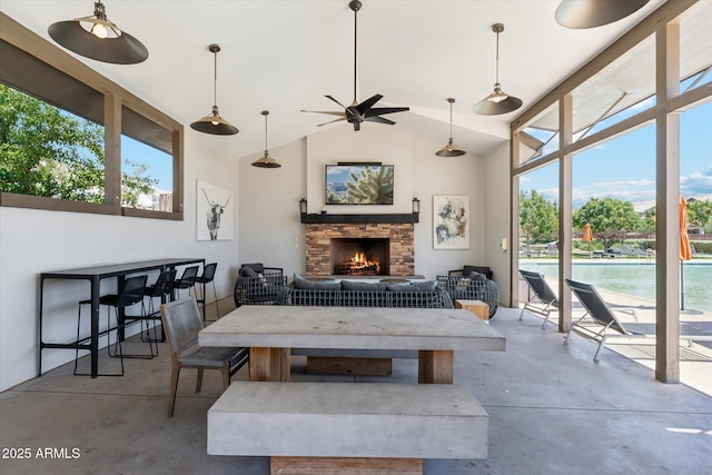732 W Flintlock Way, Chandler, AZ 85286 - living room featuring finished concrete flooring, a fireplace, plenty of natural light, a ceiling fan, and high vaulted ceiling