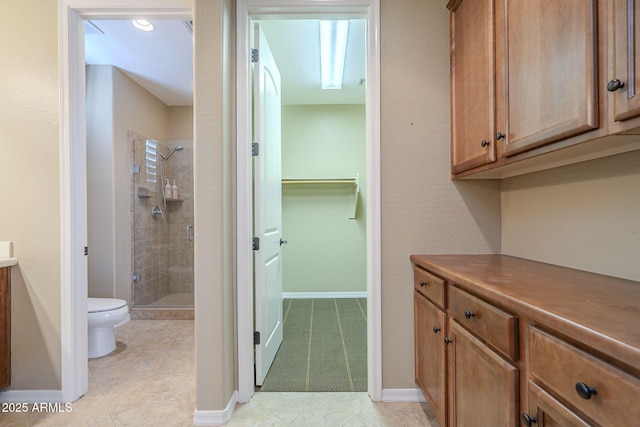 4497 E Ficus Way, Gilbert, AZ 85298 - bathroom featuring baseboards, a stall shower, and toilet