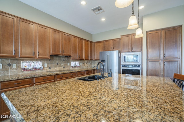 4497 E Ficus Way, Gilbert, AZ 85298 - kitchen featuring brown cabinets, appliances with stainless steel finishes, a sink, and visible vents