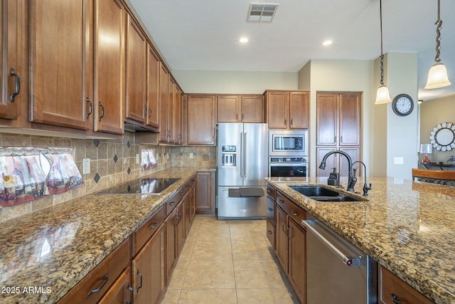 4497 E Ficus Way, Gilbert, AZ 85298 - kitchen featuring brown cabinetry, visible vents, tasteful backsplash, a sink, and stainless steel appliances