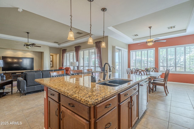 4497 E Ficus Way, Gilbert, AZ 85298 - kitchen with brown cabinets, a ceiling fan, a tray ceiling, and a sink
