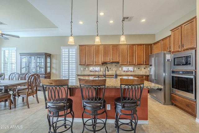 4497 E Ficus Way, Gilbert, AZ 85298 - kitchen featuring a ceiling fan, backsplash, visible vents, appliances with stainless steel finishes, and an island with sink