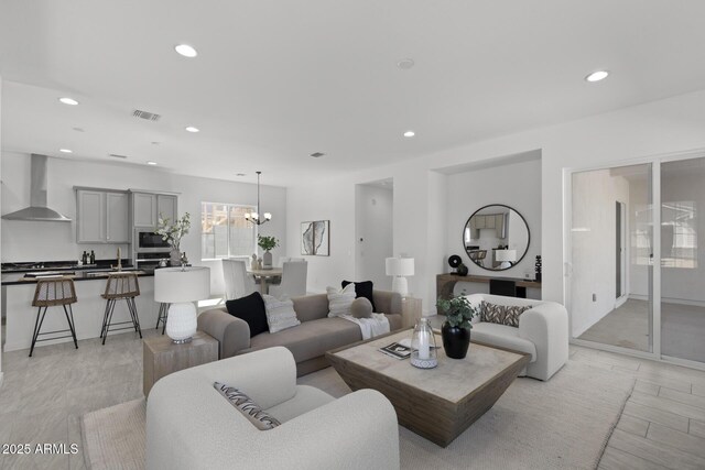 2149 W Rowel Rd, Phoenix, AZ 85085 - living room with an inviting chandelier, visible vents, recessed lighting, and light wood-style floors