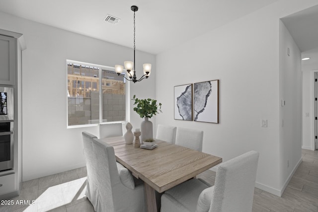 2149 W Rowel Rd, Phoenix, AZ 85085 - dining room featuring baseboards, visible vents, and an inviting chandelier