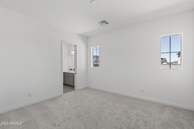 2149 W Rowel Rd, Phoenix, AZ 85085 - empty room featuring visible vents, baseboards, light colored carpet, and a healthy amount of sunlight