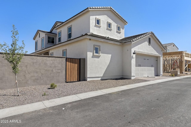 2149 W Rowel Rd, Phoenix, AZ 85085 - view of front of home featuring a garage, stucco siding, a gate, and fence