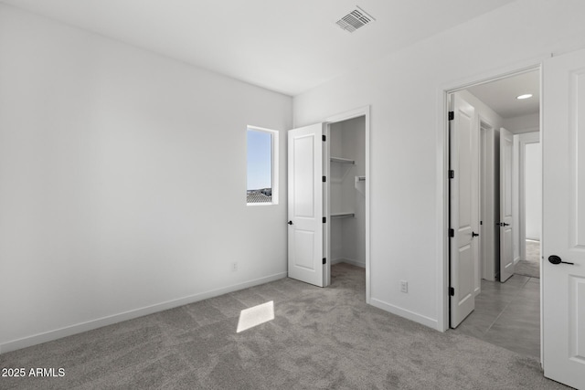 2149 W Rowel Rd, Phoenix, AZ 85085 - unfurnished bedroom with visible vents, a closet, baseboards, carpet, and a spacious closet