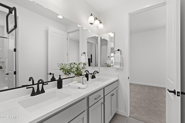 2149 W Rowel Rd, Phoenix, AZ 85085 - bathroom featuring tile patterned flooring, double vanity, a sink, and baseboards