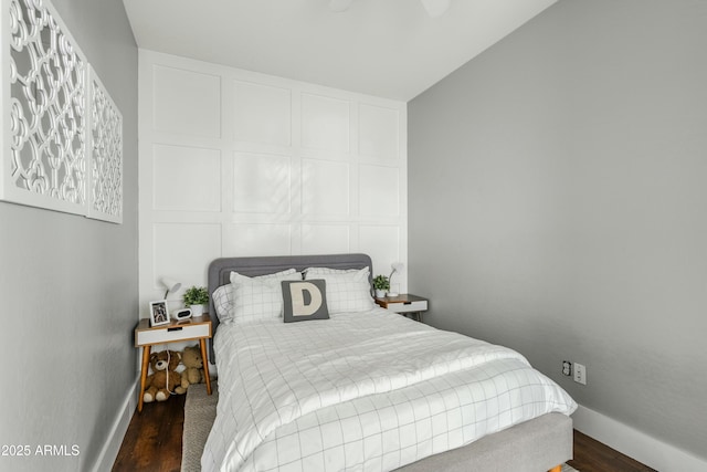 bedroom with baseboards and wood finished floors