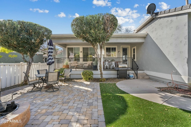 view of patio / terrace featuring outdoor dining space, fence, and grilling area