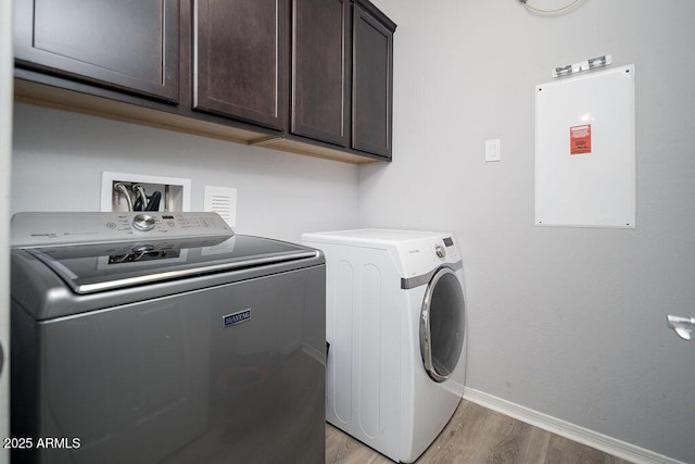 2321 W Brookhart Way, Phoenix, AZ 85085 - washroom featuring independent washer and dryer, baseboards, cabinet space, and light wood-style flooring