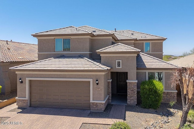 2321 W Brookhart Way, Phoenix, AZ 85085 - prairie-style house featuring stone siding, stucco siding, decorative driveway, a garage, and a tiled roof