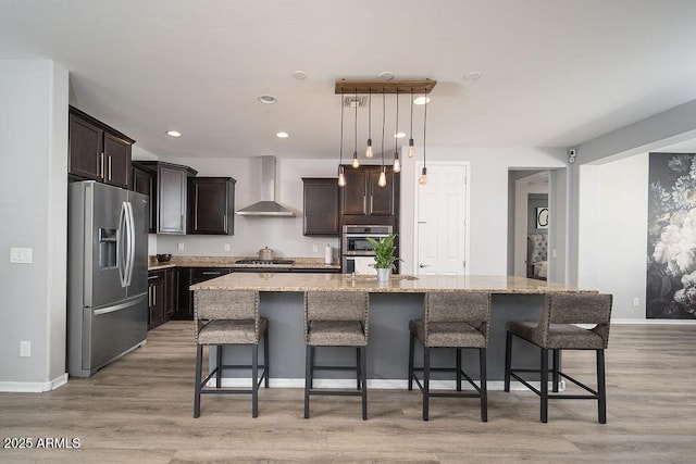 2321 W Brookhart Way, Phoenix, AZ 85085 - kitchen with appliances with stainless steel finishes, wall chimney exhaust hood, dark brown cabinetry, a large island, and light stone countertops