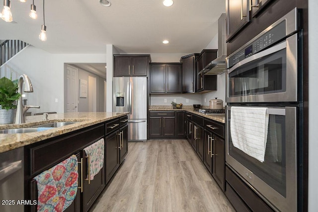 2321 W Brookhart Way, Phoenix, AZ 85085 - kitchen featuring appliances with stainless steel finishes, a sink, light wood finished floors, light stone countertops, and pendant lighting