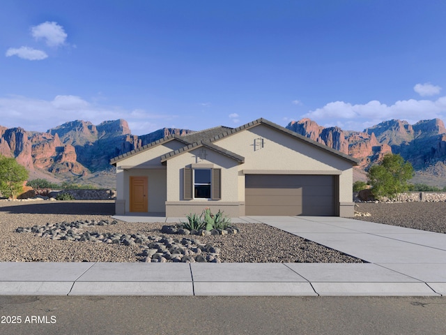 view of front of property with a mountain view and a garage