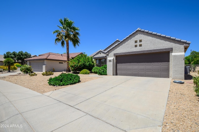 19892 N Shadow Mountain Dr, Surprise, AZ 85374 - ranch-style home with a tiled roof, a garage, stucco siding, and driveway