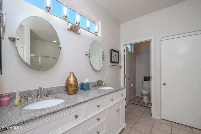 19892 N Shadow Mountain Dr, Surprise, AZ 85374 - full bath with a sink, tile patterned floors, toilet, and double vanity