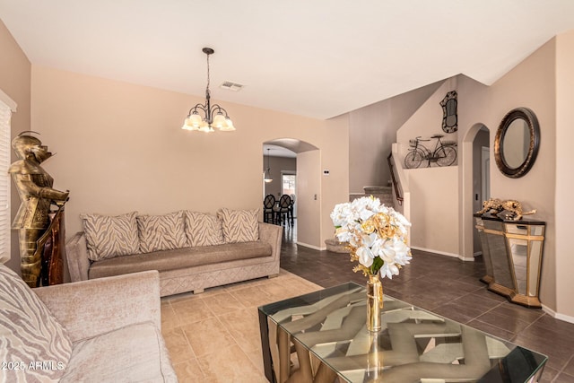 living room featuring tile patterned flooring and an inviting chandelier