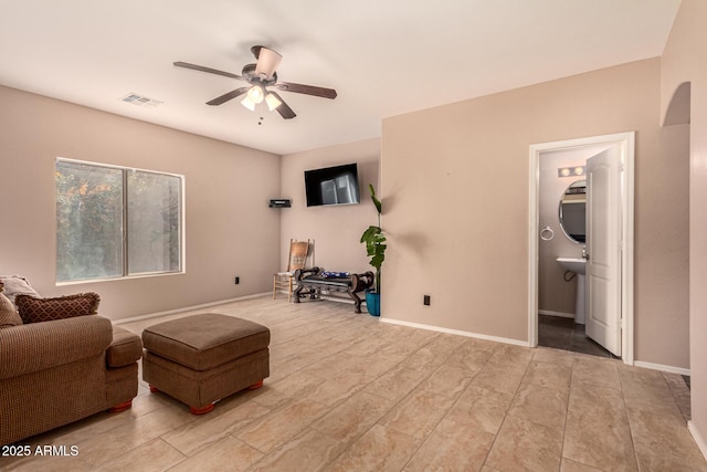 sitting room featuring ceiling fan