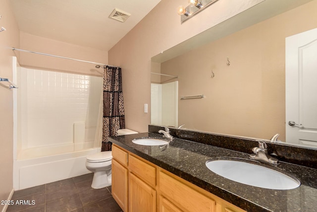 full bathroom with tile patterned flooring, shower / tub combo, vanity, and toilet