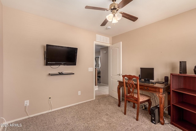 carpeted office space with ceiling fan