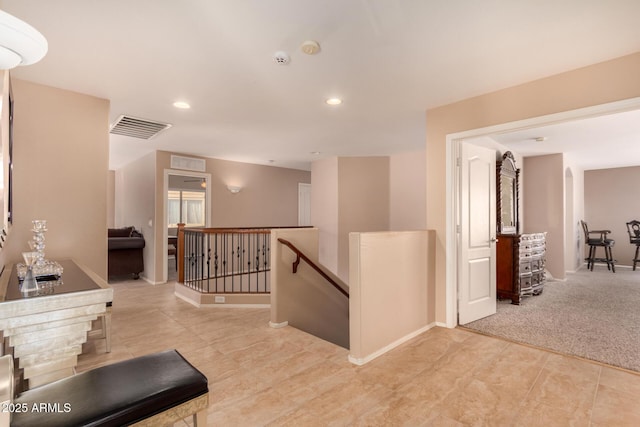 hallway with light colored carpet