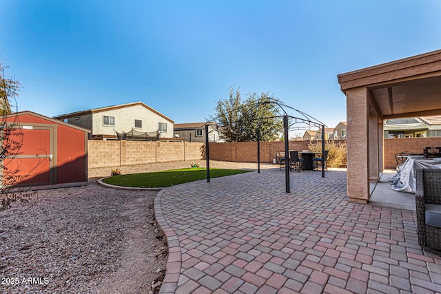 view of patio / terrace with a storage shed