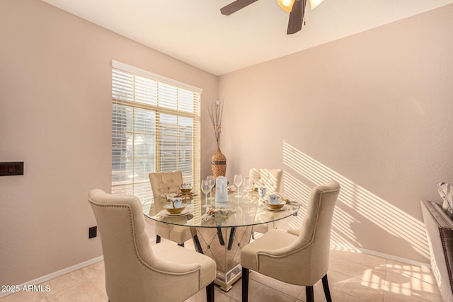 tiled dining area featuring ceiling fan