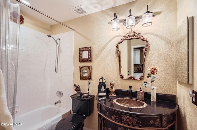 full bath featuring a textured wall, shower / tub combo, vanity, and visible vents