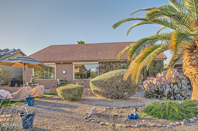 view of front of property featuring a tile roof and stucco siding