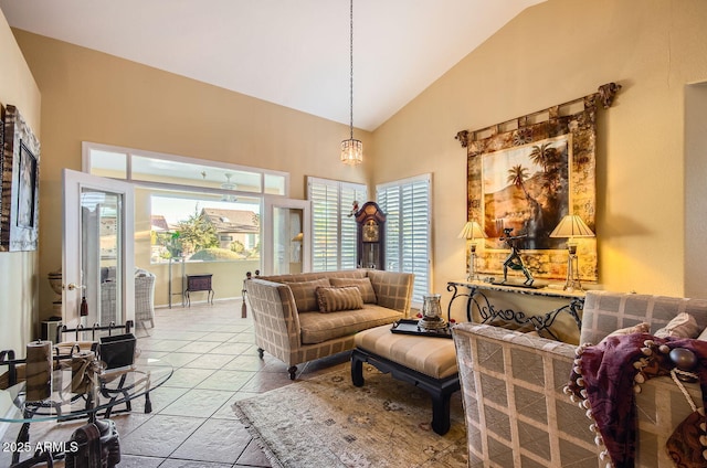 living area with tile patterned flooring and high vaulted ceiling