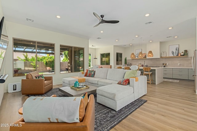 living room featuring light wood-style floors, recessed lighting, and ceiling fan